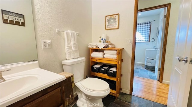 bathroom with vanity, wood-type flooring, and toilet