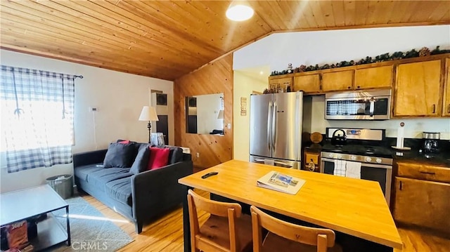 kitchen featuring appliances with stainless steel finishes, light hardwood / wood-style floors, vaulted ceiling, and wooden ceiling