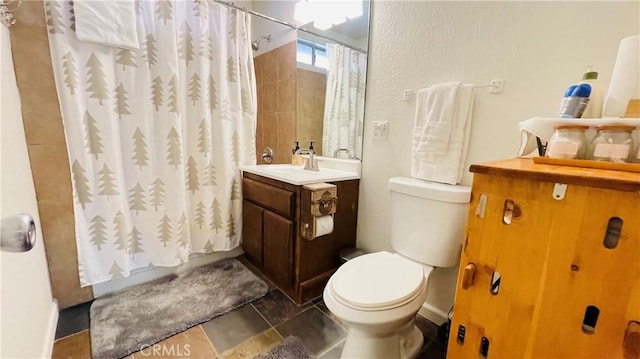 bathroom with curtained shower, vanity, and toilet