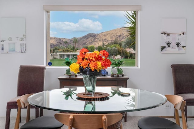 dining room with carpet flooring and a mountain view