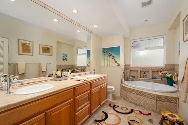 bathroom featuring plenty of natural light, tiled tub, toilet, and vanity