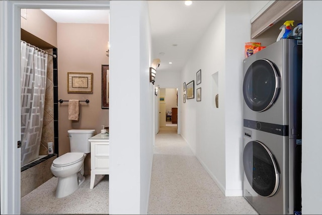 laundry room featuring stacked washer and clothes dryer