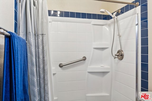 bathroom with a shower with shower curtain