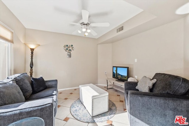 tiled living room with ceiling fan