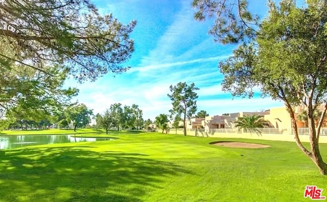 surrounding community featuring a yard and a water view