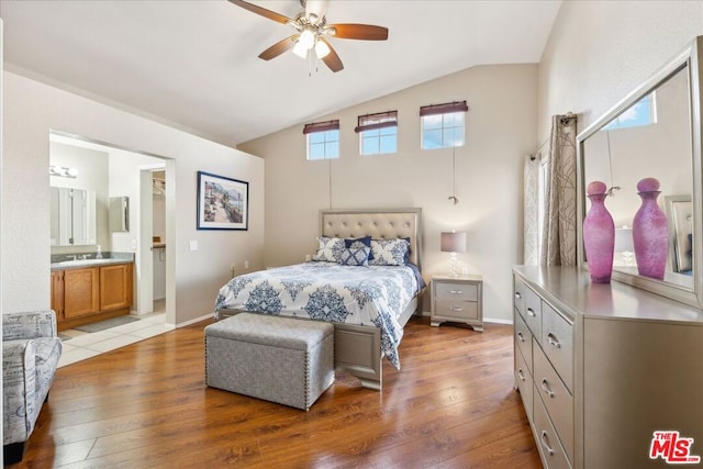 bedroom featuring light hardwood / wood-style flooring, multiple windows, and lofted ceiling