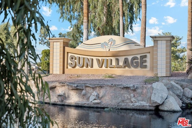 community sign with a water view