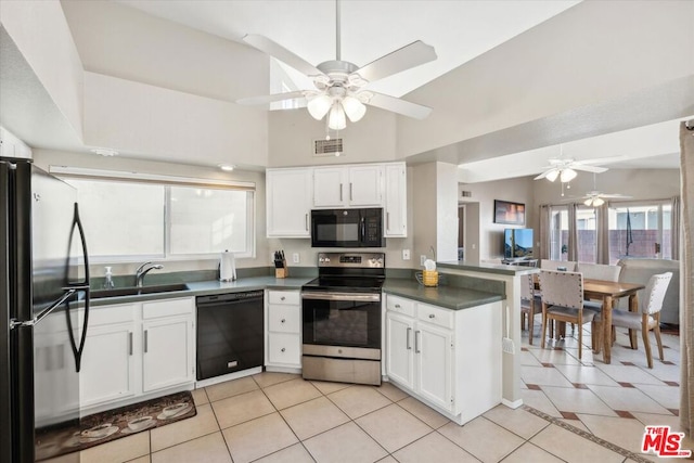 kitchen with white cabinets, black appliances, and light tile patterned floors