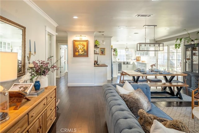 living room with dark wood-type flooring and crown molding