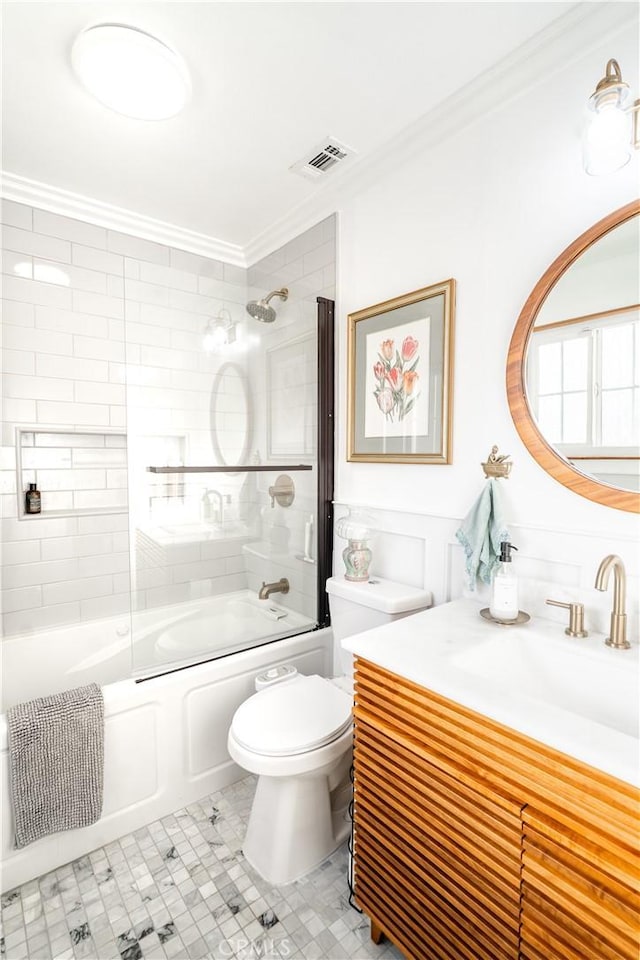 full bathroom featuring toilet, vanity, tile patterned flooring, enclosed tub / shower combo, and ornamental molding