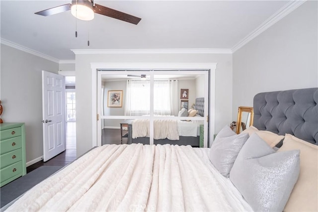 bedroom featuring ceiling fan, dark wood-type flooring, multiple windows, and a closet