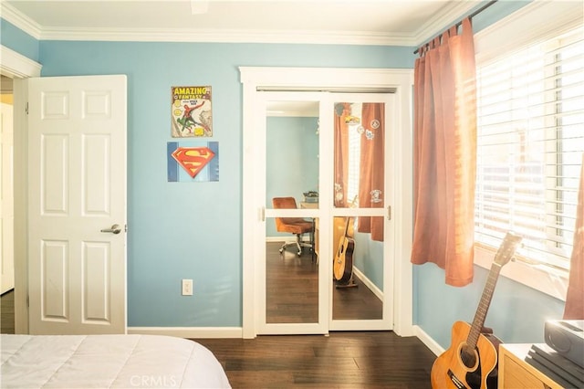 bedroom featuring dark wood-type flooring, a closet, and crown molding