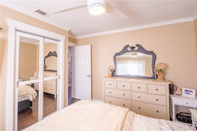 bedroom featuring ceiling fan, ornamental molding, and hardwood / wood-style floors