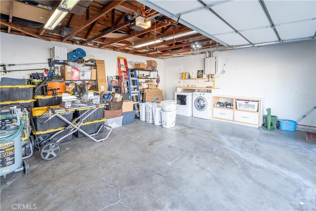 garage featuring washer and dryer, a garage door opener, and a workshop area