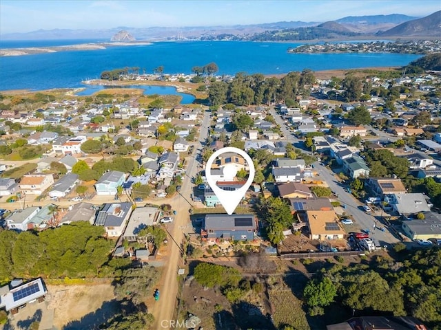 birds eye view of property featuring a water and mountain view