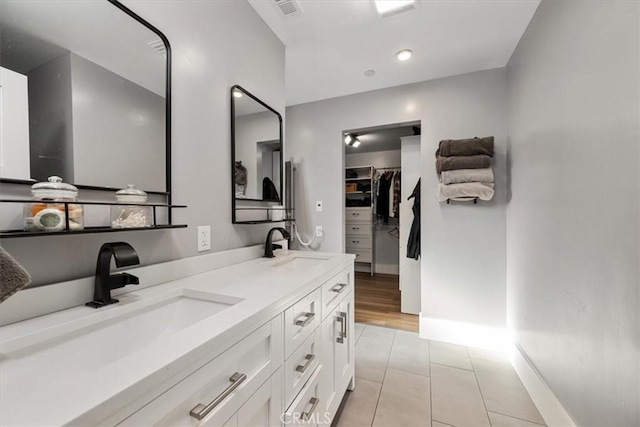 bathroom with tile patterned floors and vanity