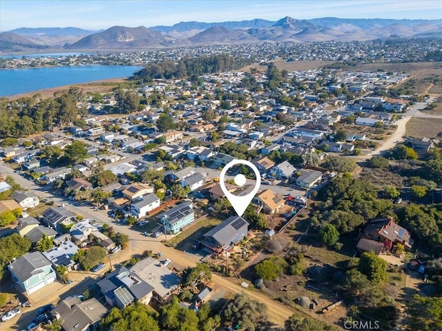 drone / aerial view featuring a water and mountain view