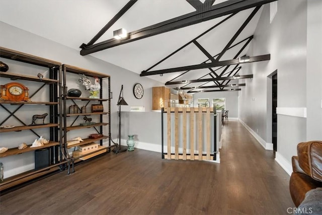 hall featuring dark hardwood / wood-style floors and vaulted ceiling with beams