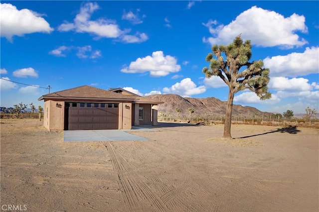 view of front of property with a mountain view and a garage