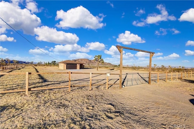 view of yard with a rural view and an outdoor structure