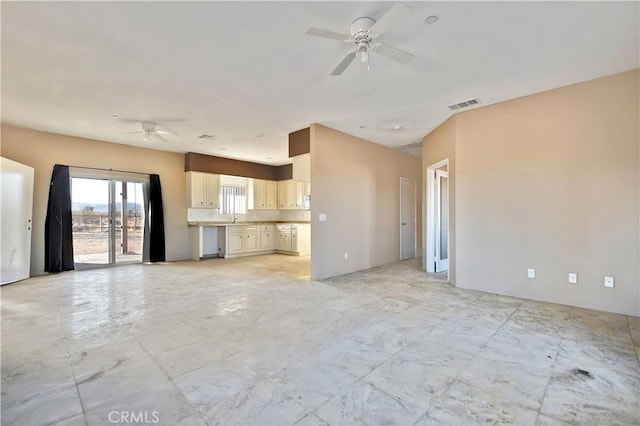 unfurnished living room with ceiling fan