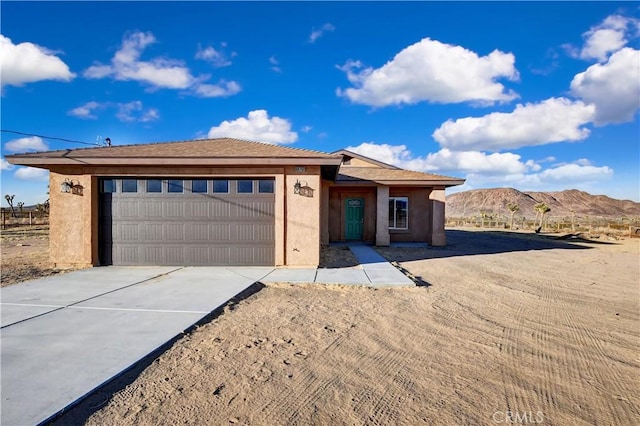 prairie-style house featuring a mountain view and a garage