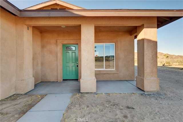 property entrance featuring a porch