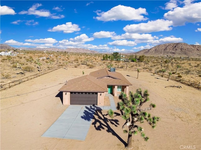 view of front of property with a mountain view and a garage