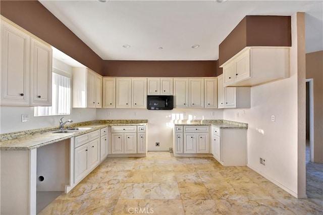 kitchen featuring sink and white cabinets