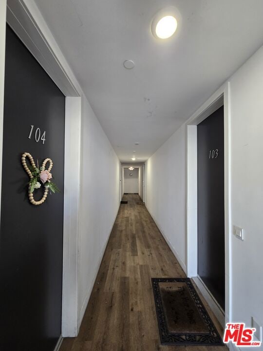 hall with hardwood / wood-style flooring