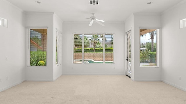 unfurnished room featuring light colored carpet, ceiling fan, and ornamental molding