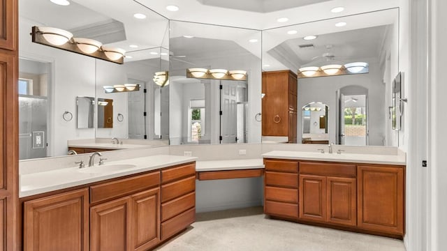 bathroom featuring vanity, a tray ceiling, ceiling fan, and crown molding