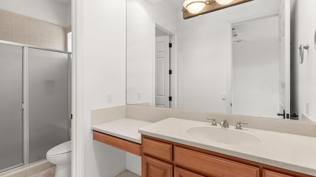 bathroom featuring ceiling fan, toilet, vanity, and walk in shower