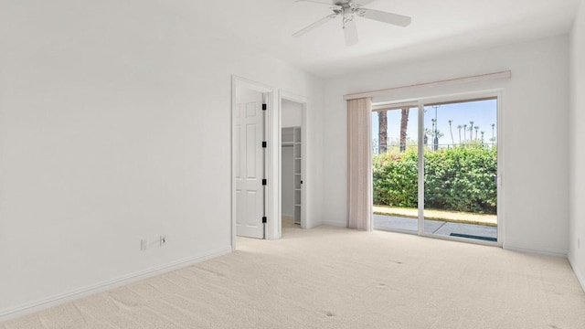 spare room with light carpet and ceiling fan