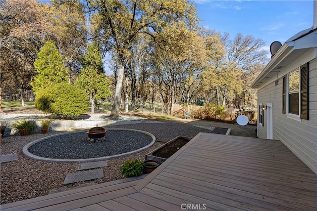 wooden deck featuring an outdoor fire pit