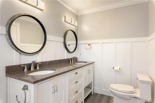 bathroom with vanity, hardwood / wood-style flooring, toilet, and ornamental molding