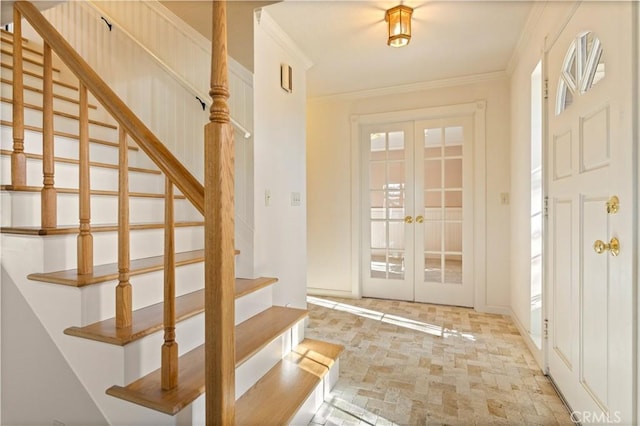 entrance foyer featuring ornamental molding and french doors