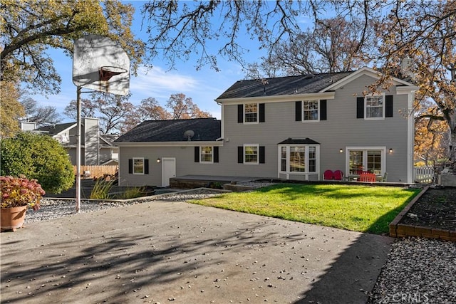 view of front of property with basketball court and a front yard