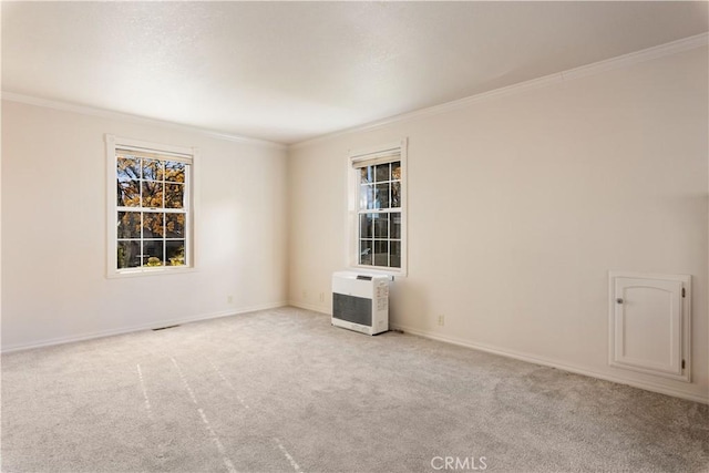 unfurnished room with light carpet, heating unit, and ornamental molding