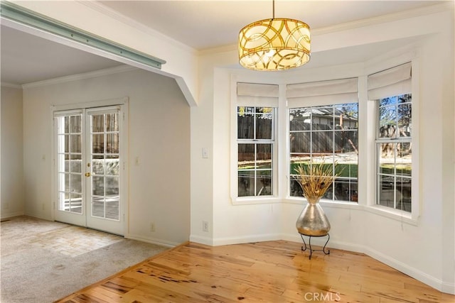 doorway to outside featuring french doors, hardwood / wood-style flooring, and ornamental molding