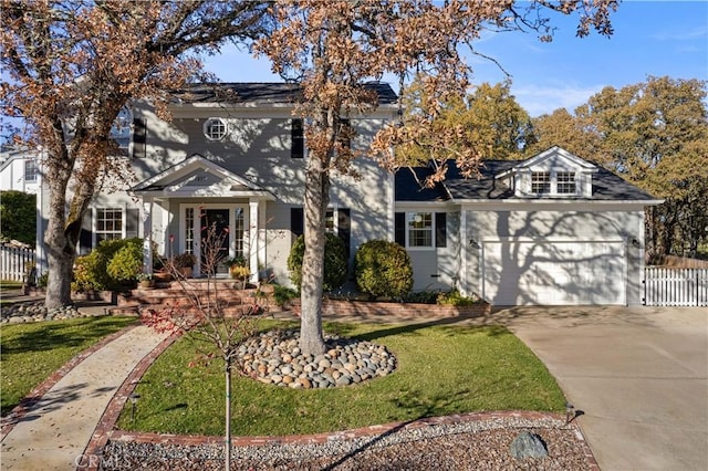 view of front facade featuring a garage and a front yard