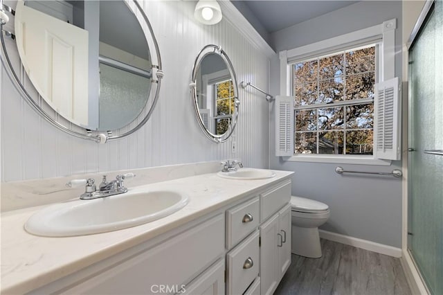 bathroom featuring hardwood / wood-style floors, vanity, and toilet