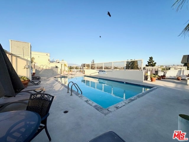 view of swimming pool with a patio