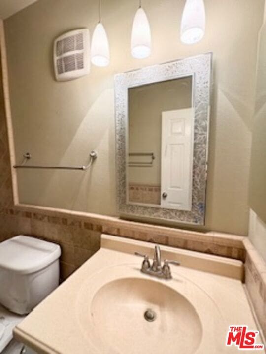 bathroom featuring toilet and vanity