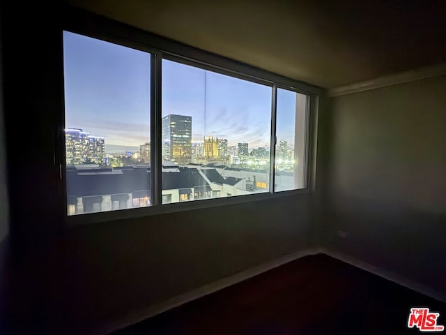 unfurnished room with crown molding