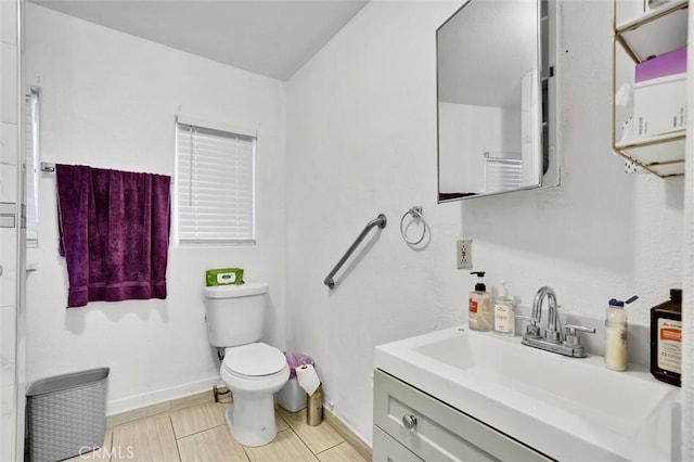 bathroom featuring tile patterned floors, vanity, and toilet