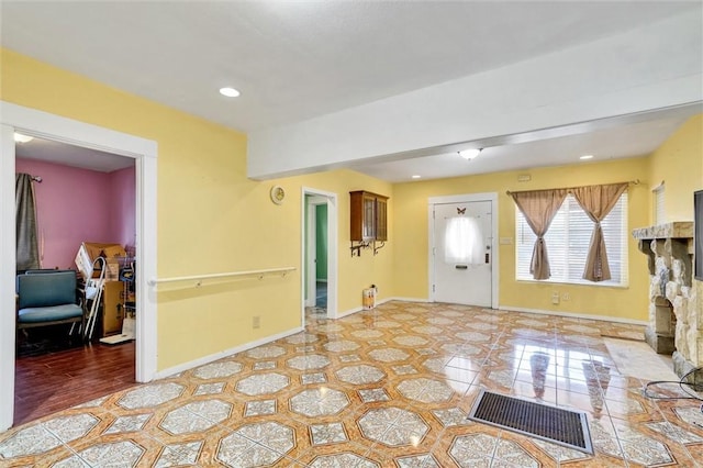 foyer entrance featuring a fireplace and tile patterned flooring