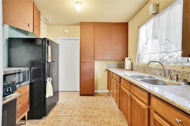 kitchen featuring sink and black appliances