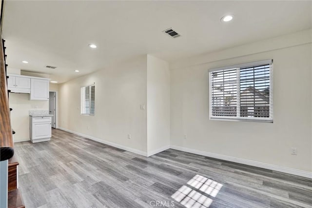 unfurnished living room with light hardwood / wood-style floors