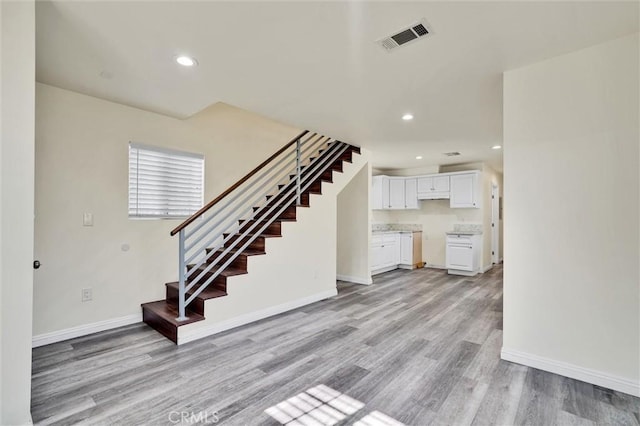 unfurnished living room with light hardwood / wood-style flooring